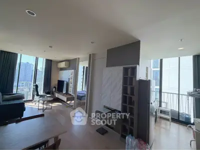 Modern open-plan living room with city view and stylish furnishings