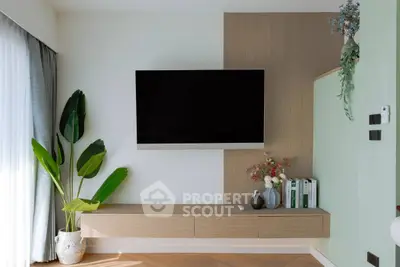 Modern living room with wall-mounted TV and stylish decor
