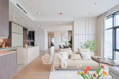 Spacious modern living room with open kitchen and city view, featuring elegant decor and natural light.