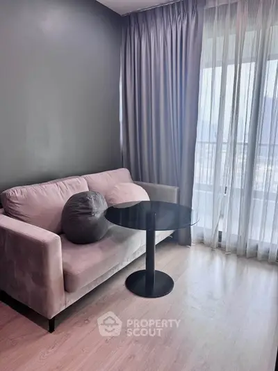 Cozy living room with modern sofa and elegant floor-to-ceiling curtains.