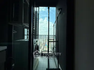High-rise apartment balcony with washing machine and stunning city view.