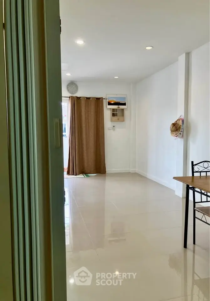 Spacious and bright living room with modern decor and large windows.