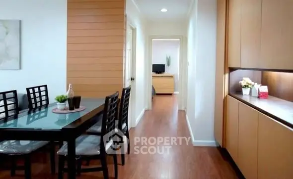 Modern dining area with wooden flooring and sleek furniture