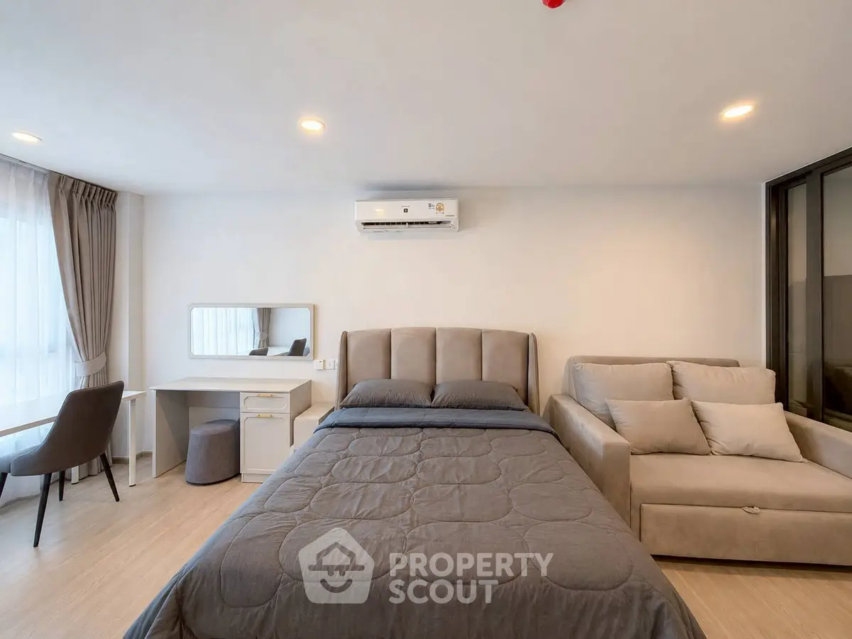 Modern bedroom with stylish furniture and natural light, featuring a cozy bed and elegant decor.