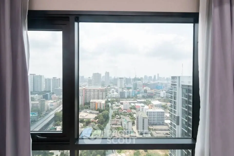Stunning cityscape view from high-rise apartment window, perfect for urban living enthusiasts.
