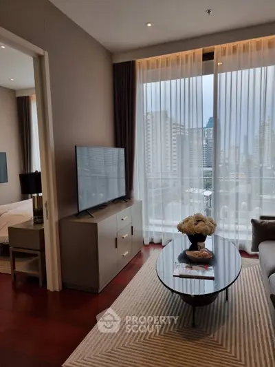 Modern living room with city view, featuring sleek furniture and large windows for natural light.