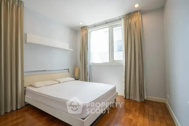 Spacious bedroom with natural light and modern decor