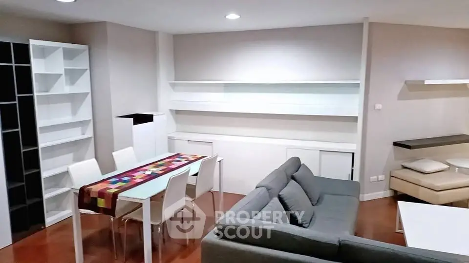 Modern living room with sleek furniture and dining area, perfect for urban living.