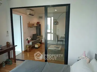 Modern apartment interior with sliding glass doors, cozy living room, and stylish decor.