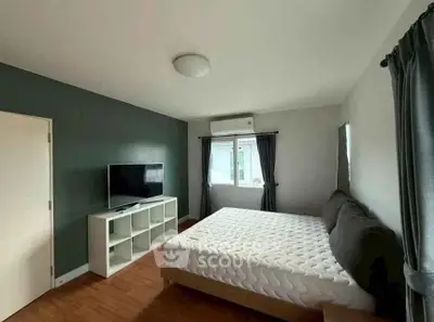 Spacious bedroom with modern decor and natural light
