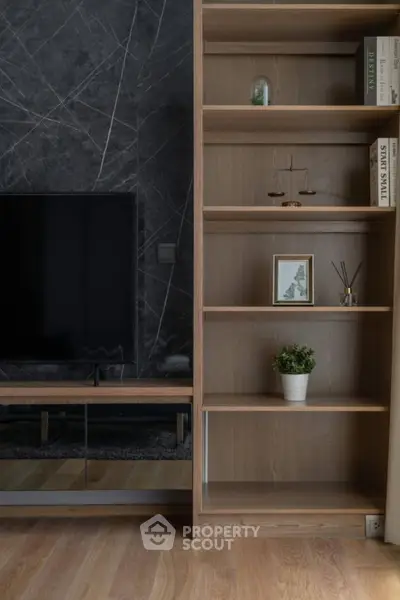 Modern living room with sleek TV unit and stylish wooden shelving