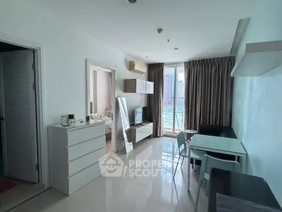 Modern apartment interior with open living area and city view.