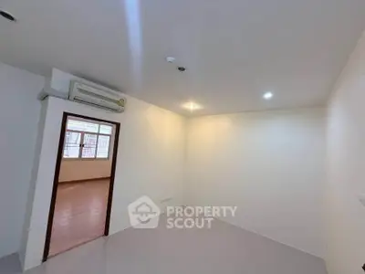 Spacious unfurnished room with air conditioning and tiled flooring