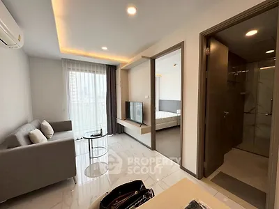 Modern apartment interior with open living room and bedroom view