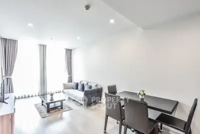 Modern living room with sleek furniture and natural light, perfect for urban living.