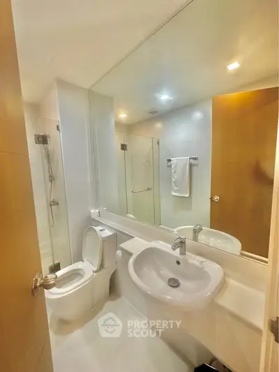 Modern bathroom with sleek fixtures and glass shower enclosure