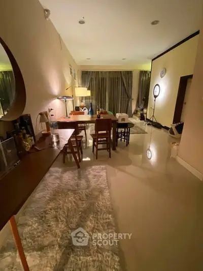 Spacious living room with modern decor and ambient lighting, perfect for relaxation and entertainment.
