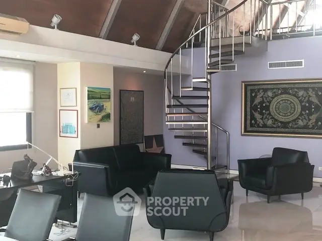 Luxurious living room with spiral staircase and modern black furniture in a stylish open-plan design.