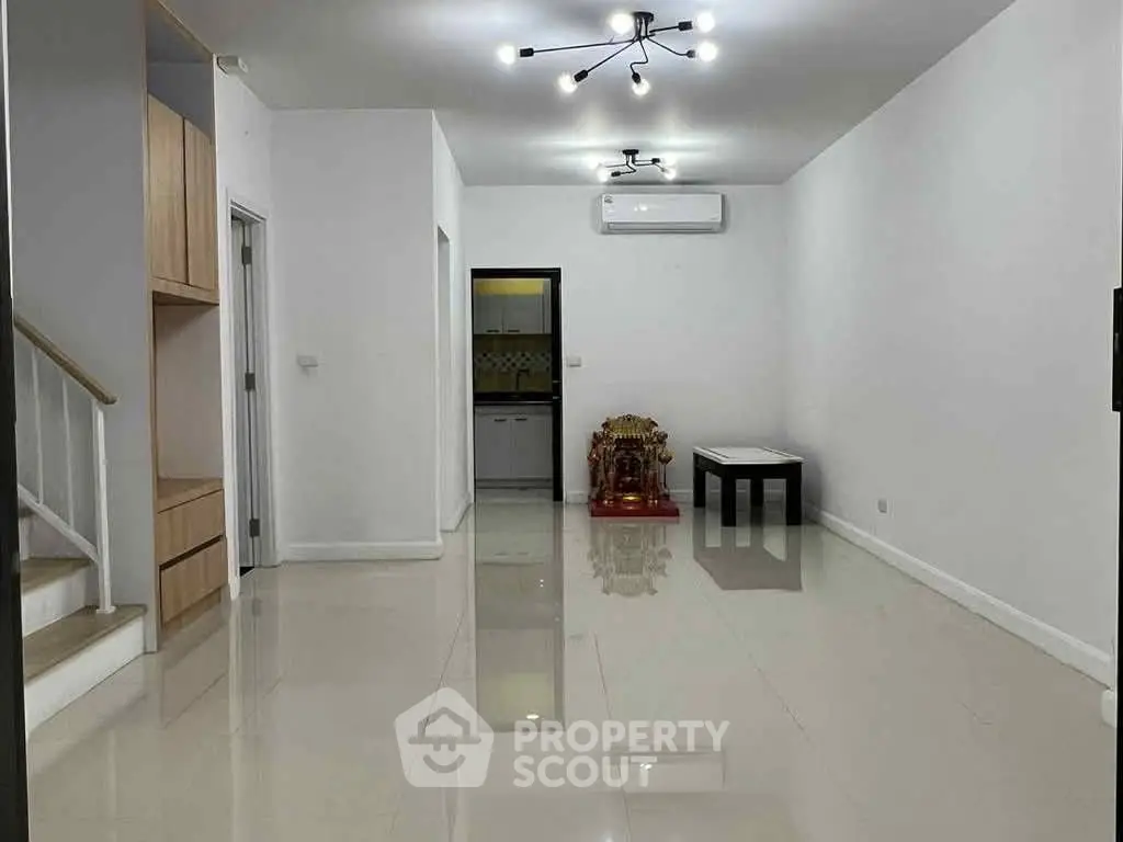 Spacious modern living room with sleek lighting and minimalist decor