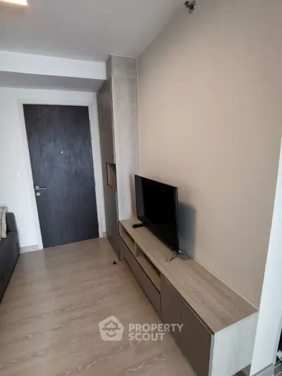 Modern living room with sleek TV stand and wooden flooring