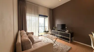 Elegant living room with modern decor and large window view