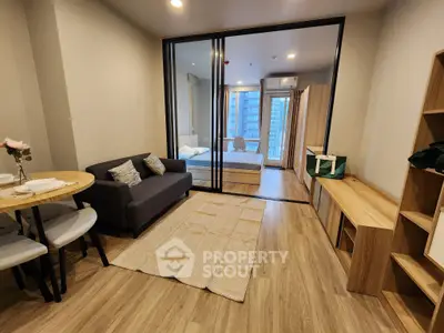 Modern open-plan living room with glass partition and stylish decor