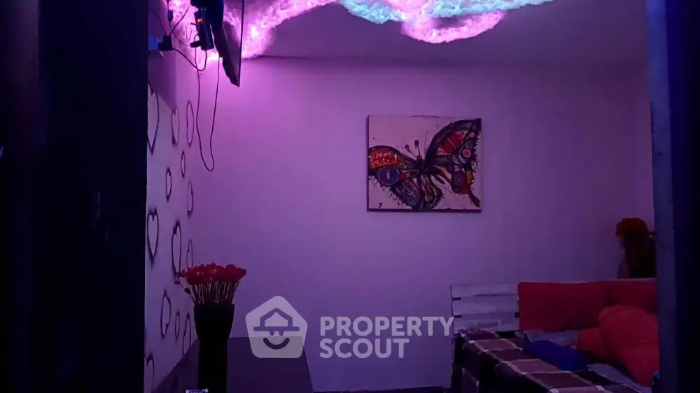 Cozy living room with vibrant butterfly artwork and ambient lighting