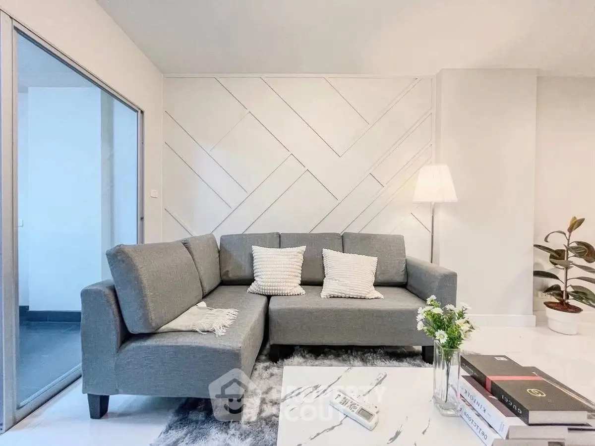Modern living room with stylish gray sofa and elegant decor