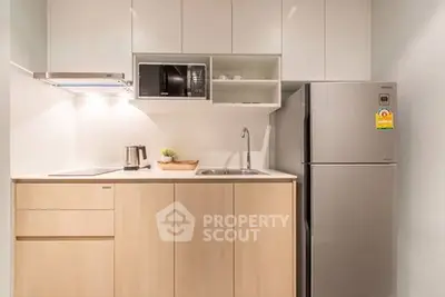 Modern compact kitchen with sleek appliances and minimalist design