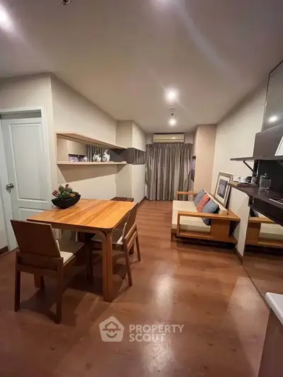 Modern living room with wooden flooring and stylish furniture in a cozy apartment setting.