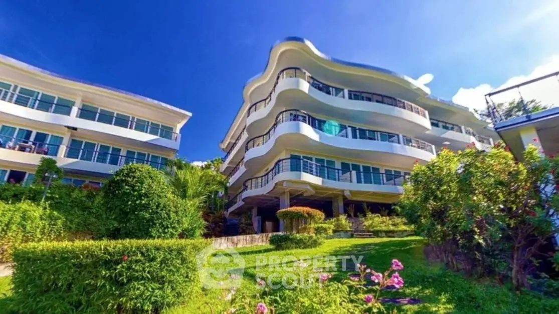 Stunning modern building with lush gardens and unique architectural design.