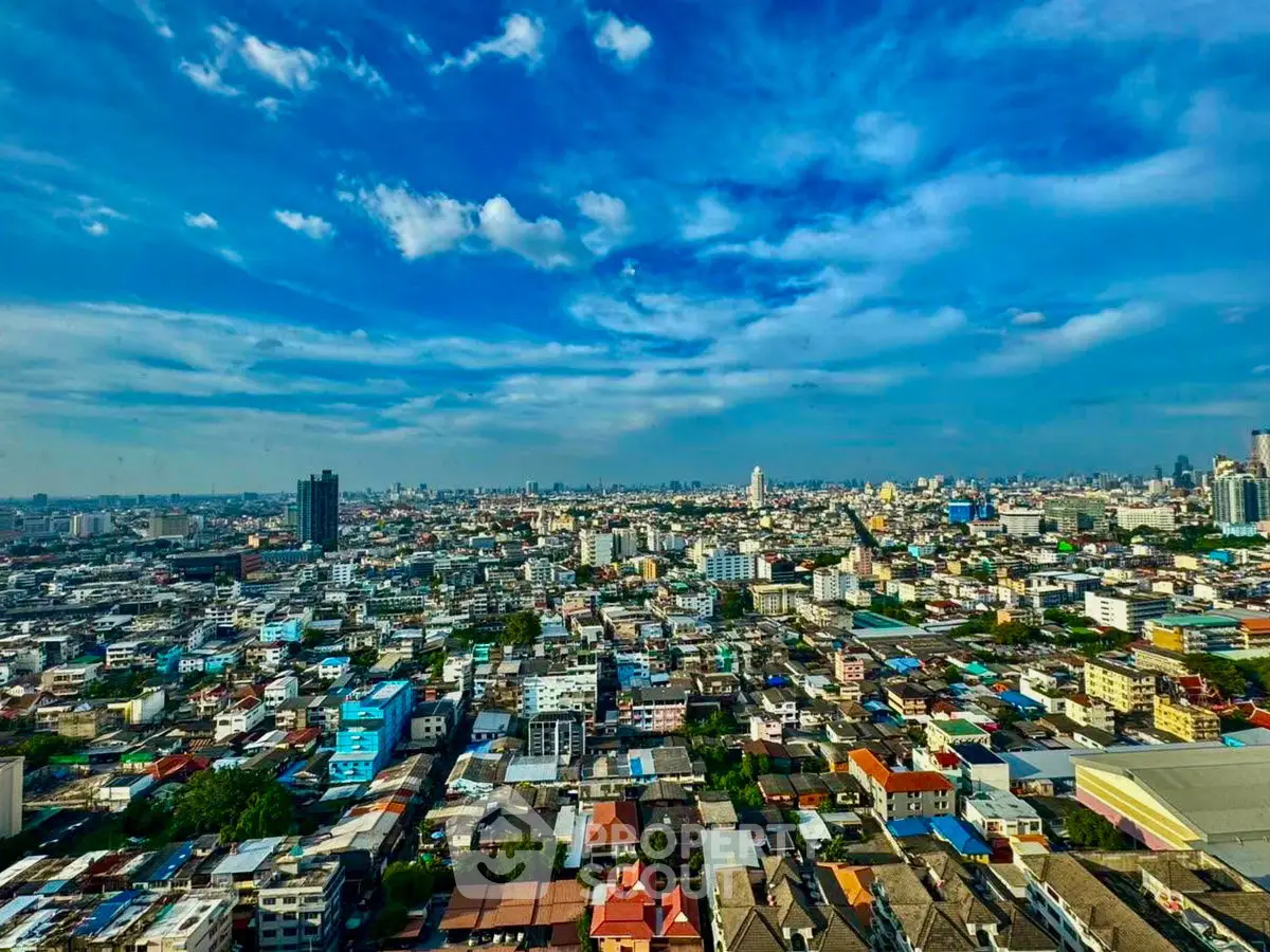 Stunning panoramic cityscape view showcasing vibrant urban skyline under a clear blue sky.