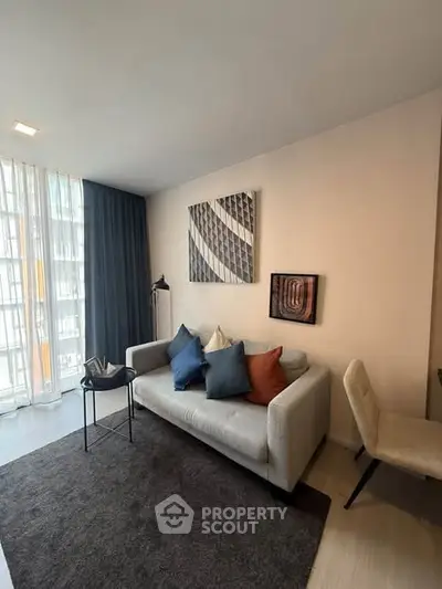 Modern living room with stylish decor and natural light in a contemporary apartment.
