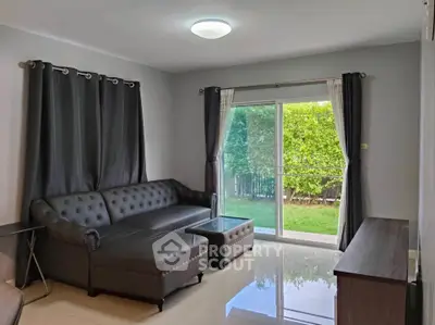 Spacious living room with modern sofa and garden view