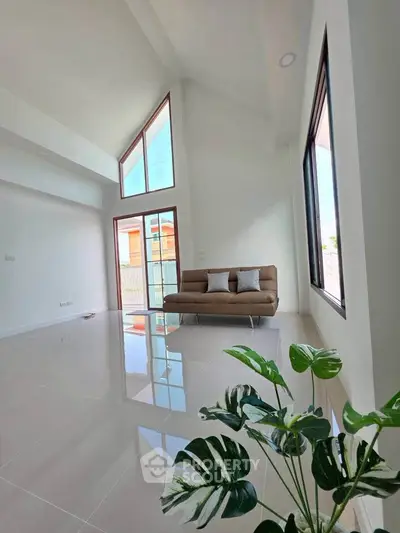 Spacious modern living room with high ceilings and large windows