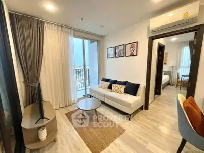 Modern living room with balcony view, stylish decor, and natural light in a cozy apartment.