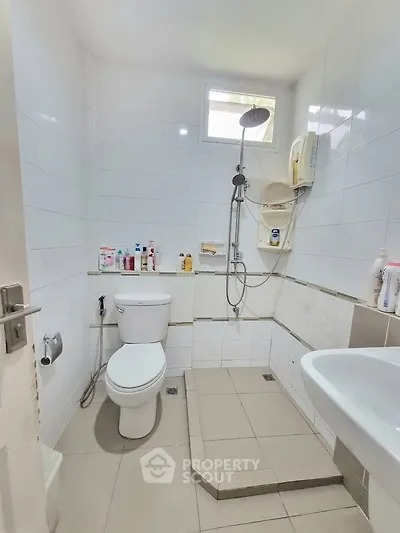 Compact bathroom with shower and modern fixtures, ideal for efficient space use.