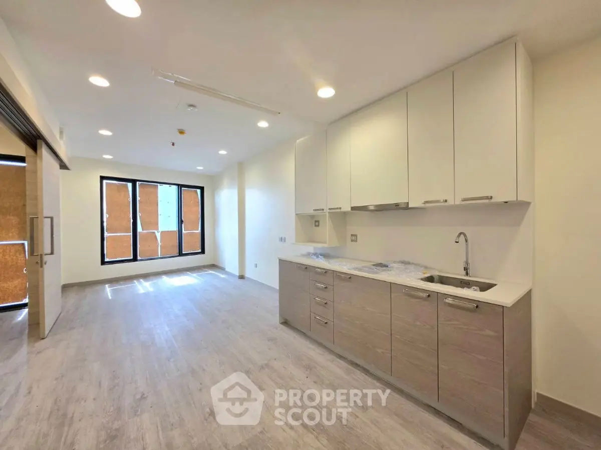 Modern open-layout kitchen with sleek cabinetry and ample natural light.