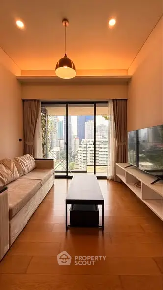 Modern living room with city view, featuring sleek furniture and floor-to-ceiling windows.