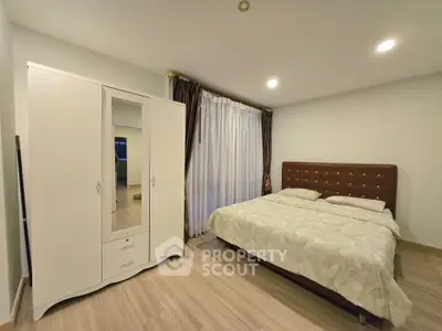 Spacious bedroom with elegant decor and large wardrobe in modern apartment