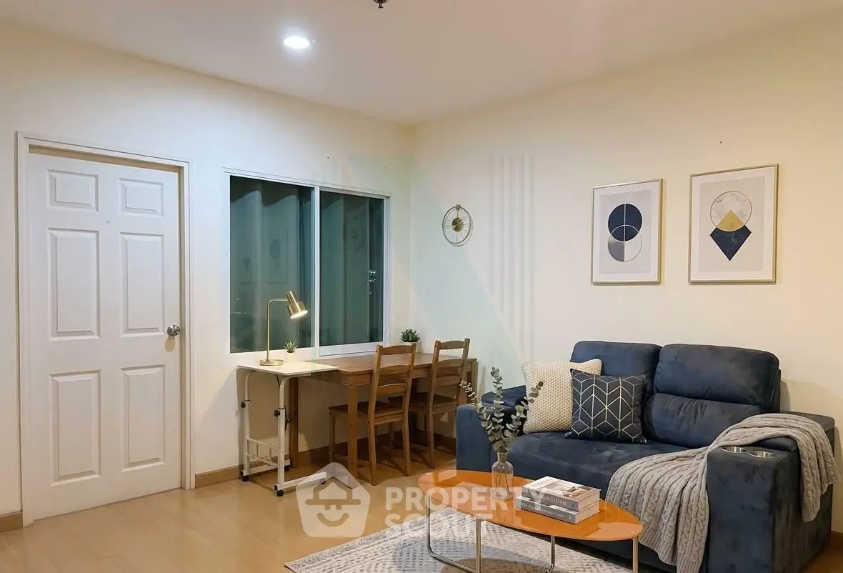 Cozy living room with modern decor and study area, perfect for relaxation and productivity.