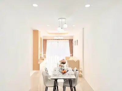 Elegant open-plan dining and living area with modern decor and natural light.