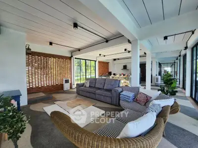 Spacious modern living room with stylish furniture and large windows offering natural light.