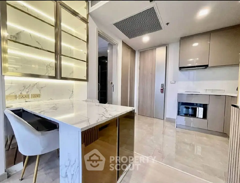 Modern kitchen with sleek cabinetry and marble countertops in a stylish apartment.