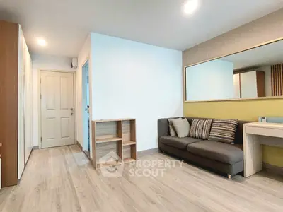 Modern living room with stylish sofa and large mirror, perfect for cozy relaxation.