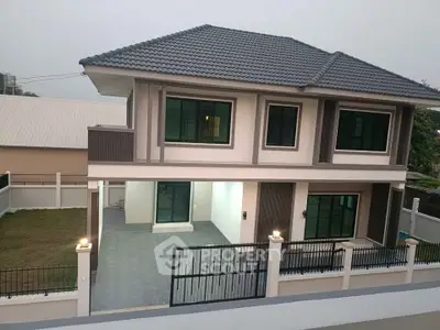Modern two-story house with spacious driveway and contemporary design.