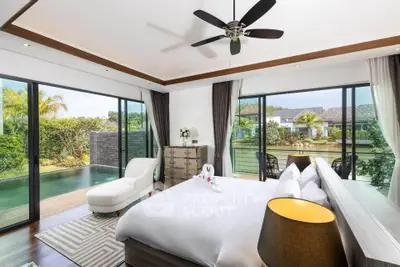 Luxurious bedroom with pool view and modern decor in tropical villa