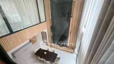 Luxurious modern living room with high ceilings and elegant dining area