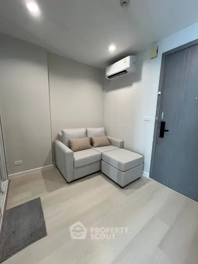Cozy living room with modern sofa and air conditioning in a stylish apartment.