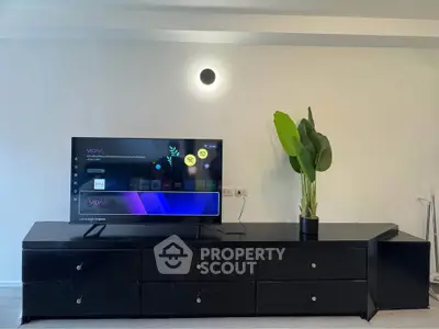 Modern living room with sleek black TV stand and stylish decor